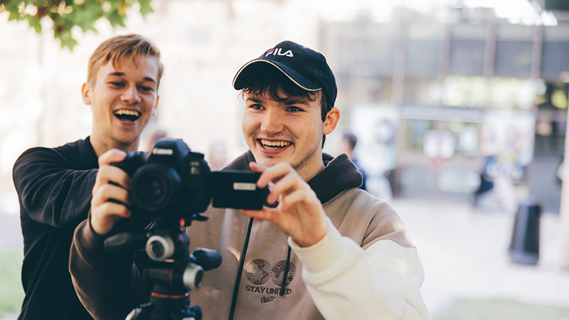 Two students filming