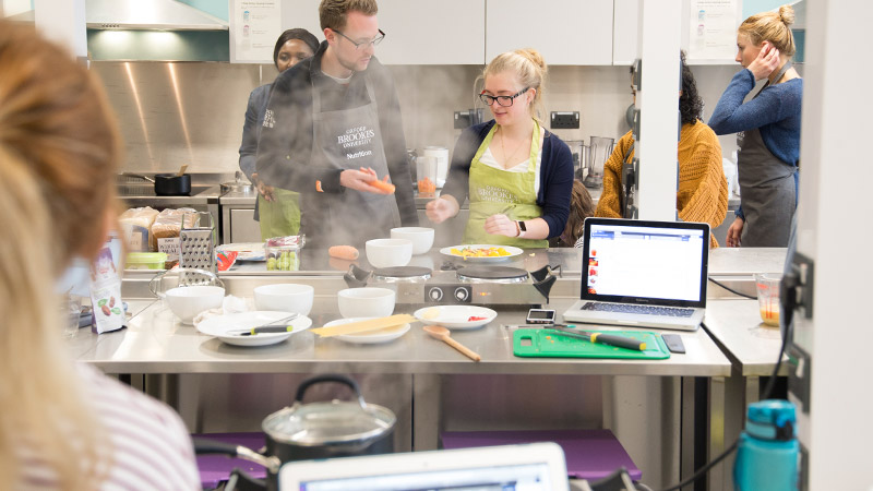 Students cooking in the nutrition kitchen