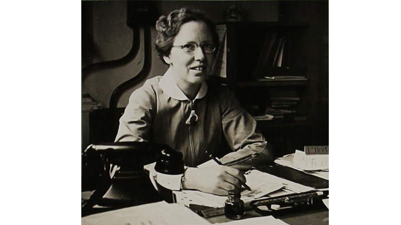 Mary Macdonald sitting at a desk.