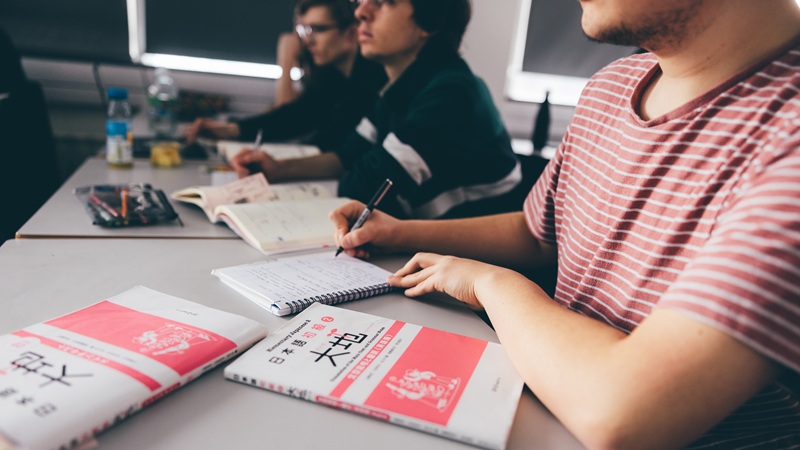 Student in class with Japanese text books