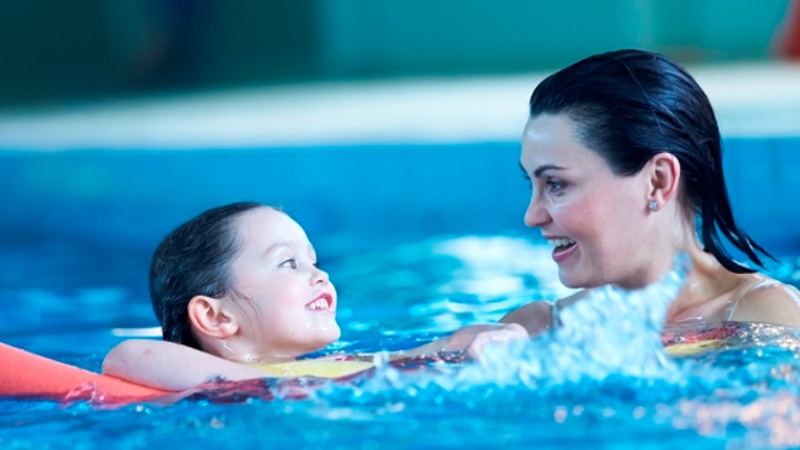 Woman and child swimming together