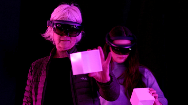 2 women wearing a VR headset