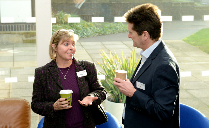 Two people chatting at a conference