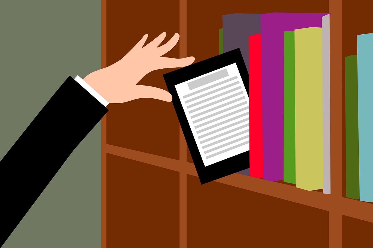 A hand reaches up to a bookshelf, and pulls an e-reader from between the books