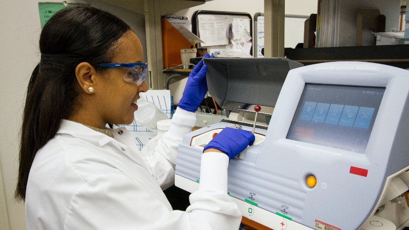 Female scientist in front of laboratory equipment