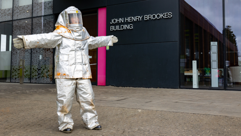 Person in space suit outside Oxford Brookes University