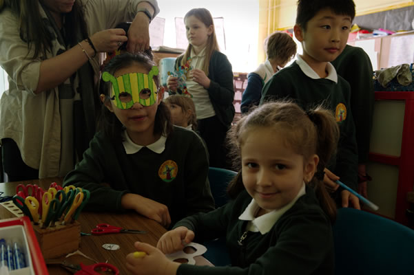 Pupils in a classroom creating a mask