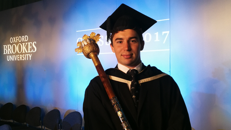 A student carrying the mace