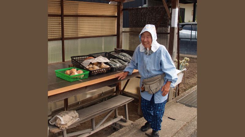 japanese market with a merchant in front of his stall