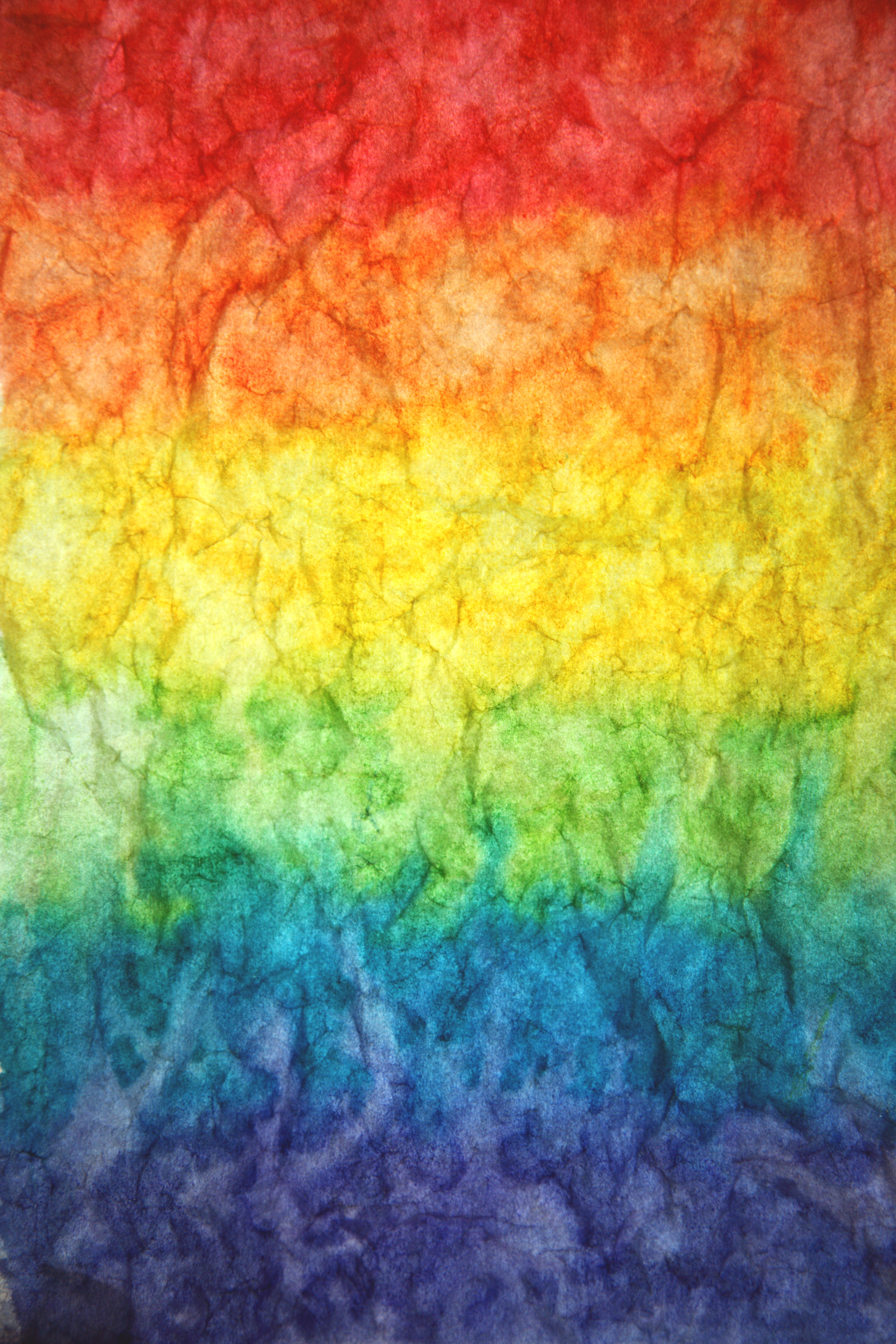 Textured paper watercolor paint rainbow background.