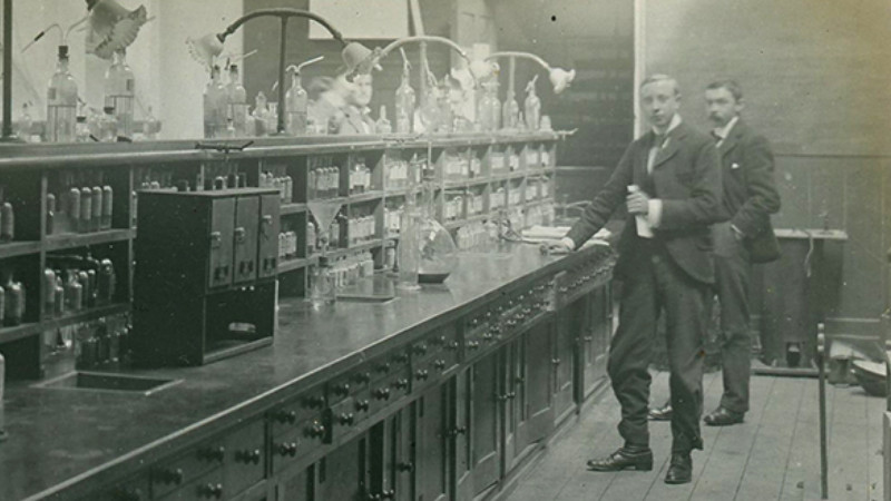 historical science laboratory bench and scientists