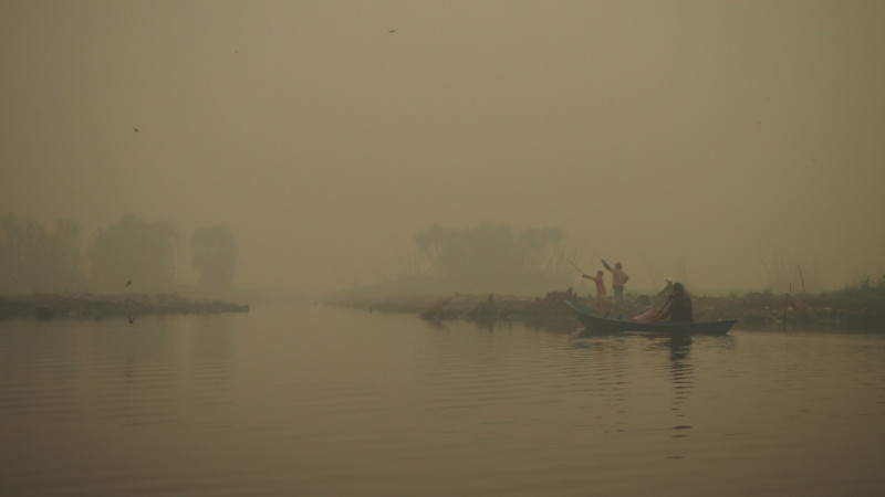 Local fishers working under thick haze conditions from peatland fires in Central Kalimantan, Indonesia.