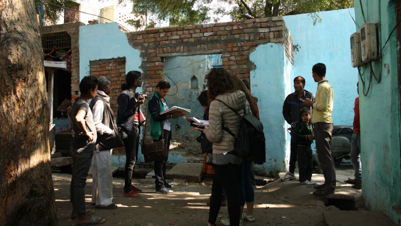 Oxford Brookes and SPA Delhi students talking to local inhabitants in a riverside neighbourhood