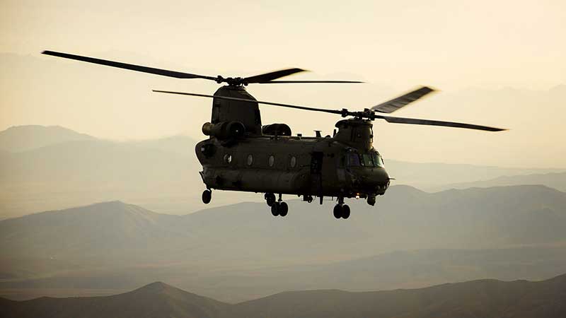 Chinook helicopter flying over desert