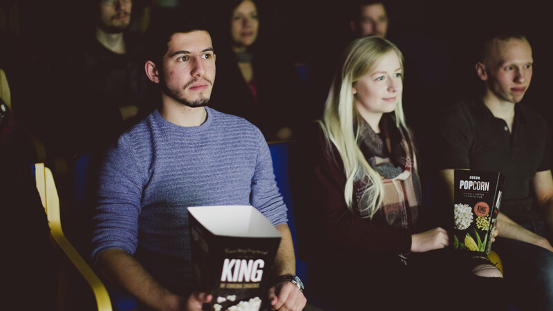 Students with popcorn in seats watching a film