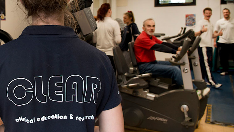 People with neurological conditions exercising in a gym under supervision