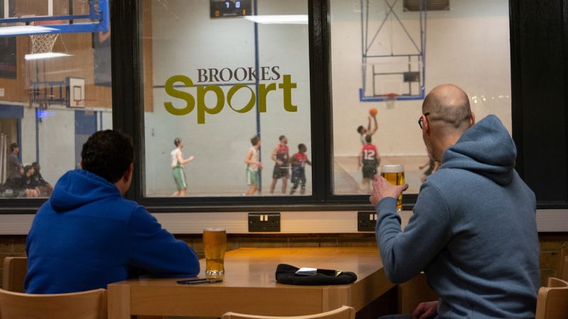 Two Sports Bar customers overlooking the sports hall