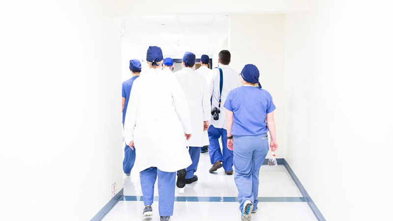 A group of nurses walking down a hallway