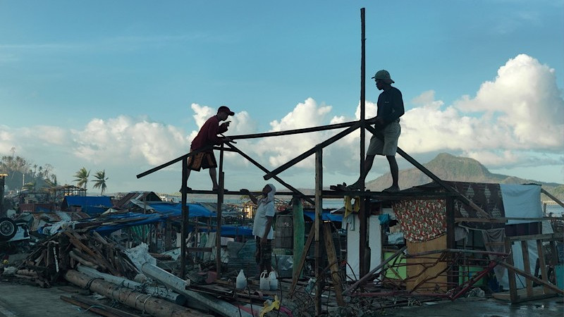 Residents rebuilding their home after it was destroyed by typhoon Haiyan, Philippines.