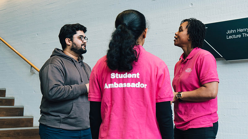 Three Student ambassadors stood together talking