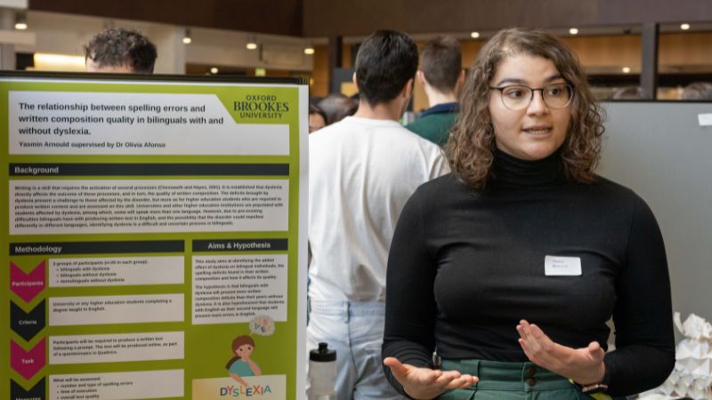 A student presents their research poster at the 2023 Get Published! event