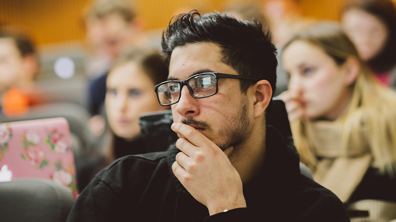 Male student listening to lecture