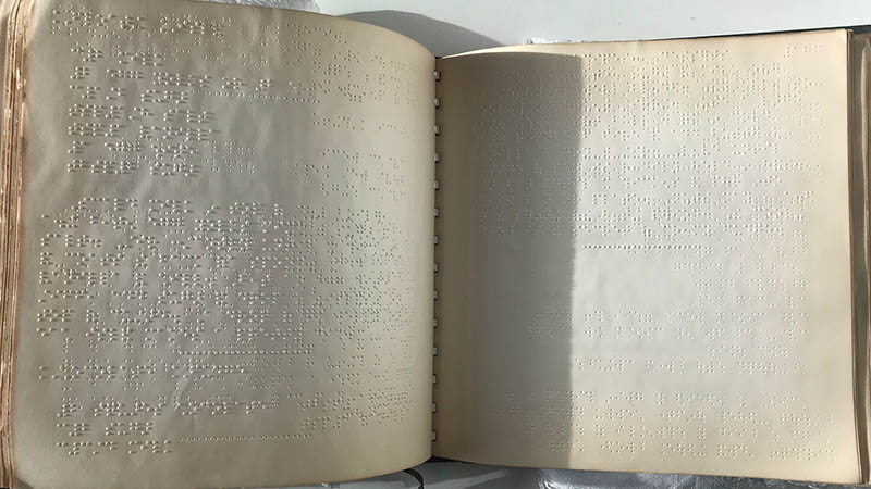 The Braille Cookbook open showing a double page spread of braille.