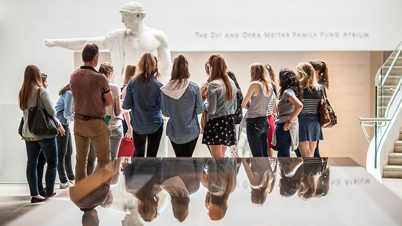 Students observing a statue