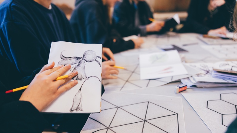 Student group sketching flowers