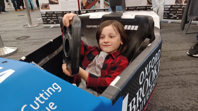 A boy driving a racing car