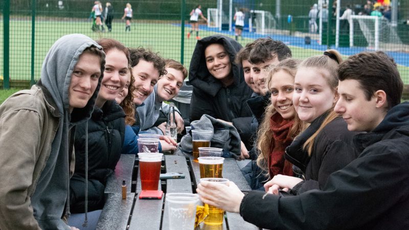Students enjoying the outdoor Sports Bar space
