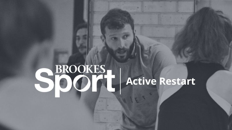 Fitness class instructor leading a spin class with Brookes Sport logo and Active Restart imposed over the top