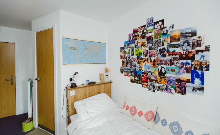 Bed with photos arranged on the wall
