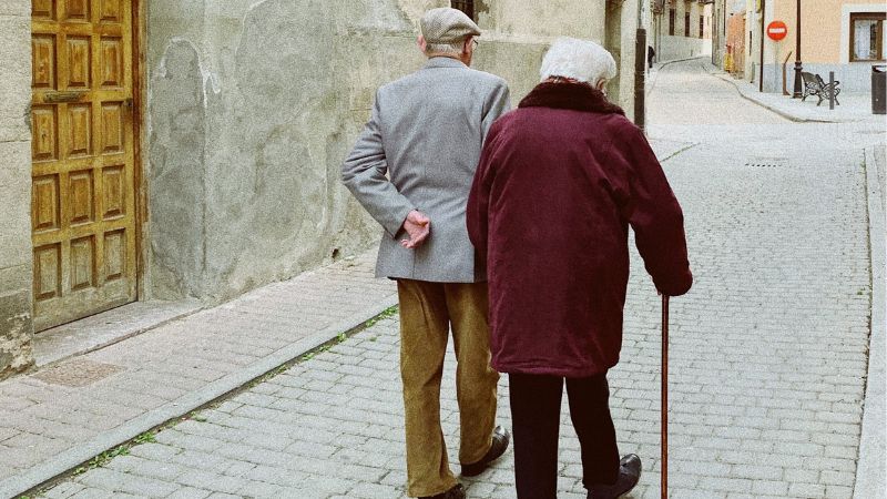 older couple walk on street