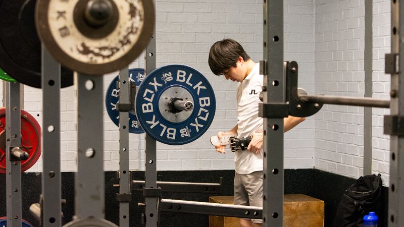Man setting up to squat at gym