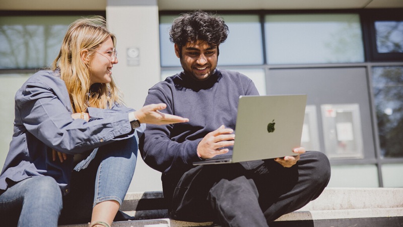 Two students discussing an essay