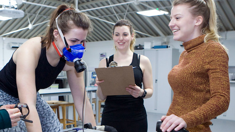 Student researchers performing VO2 max test in sports laboratory