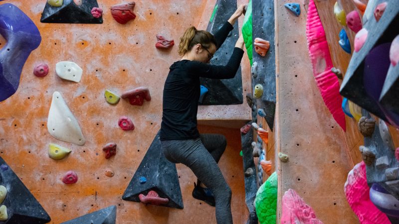 Student bouldering in climbing wall