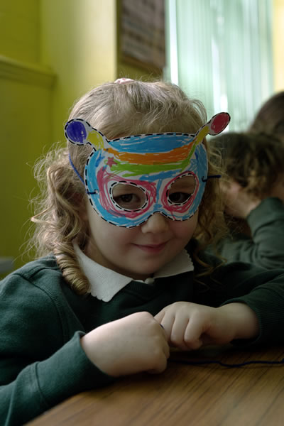 Pupil wearing a colourful mask