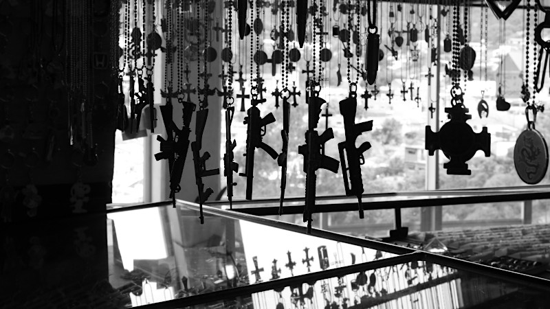 Machine guns and crosses hanging in shop window