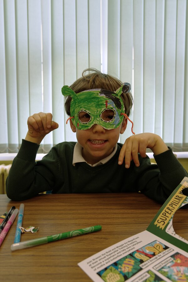 Pupil wearing a green mask