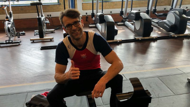 Georg with a thumbs up sat on rowing erg