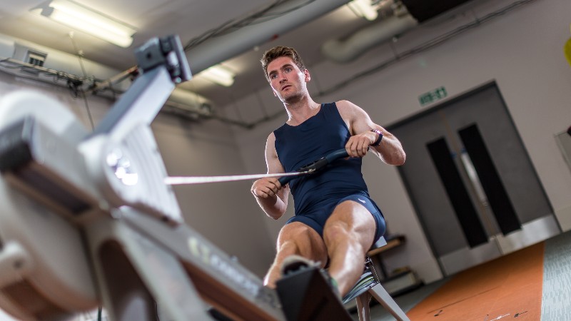 A person using a rowing machine