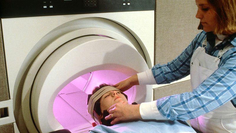 Nurse putting patient in MRI scanner