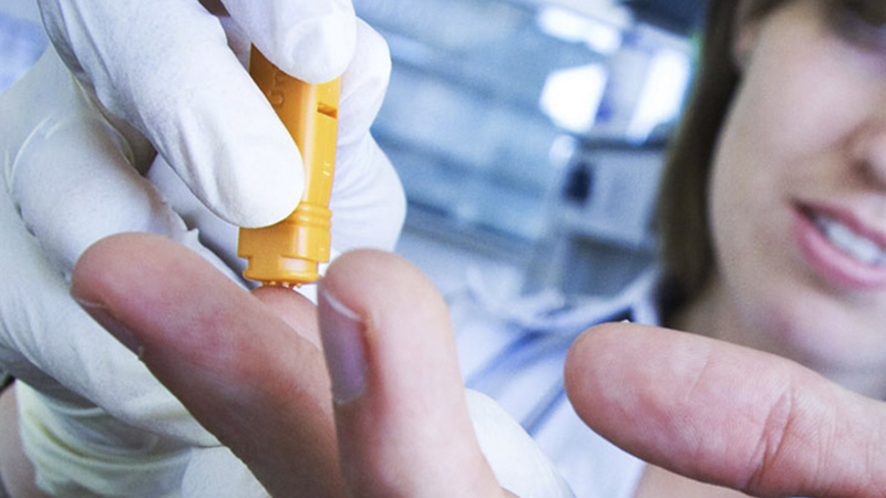 Researcher taking a small blood sample