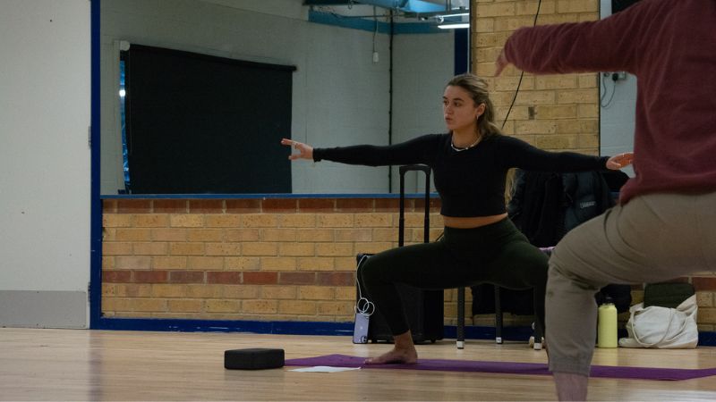 Instructor leading Pilates class